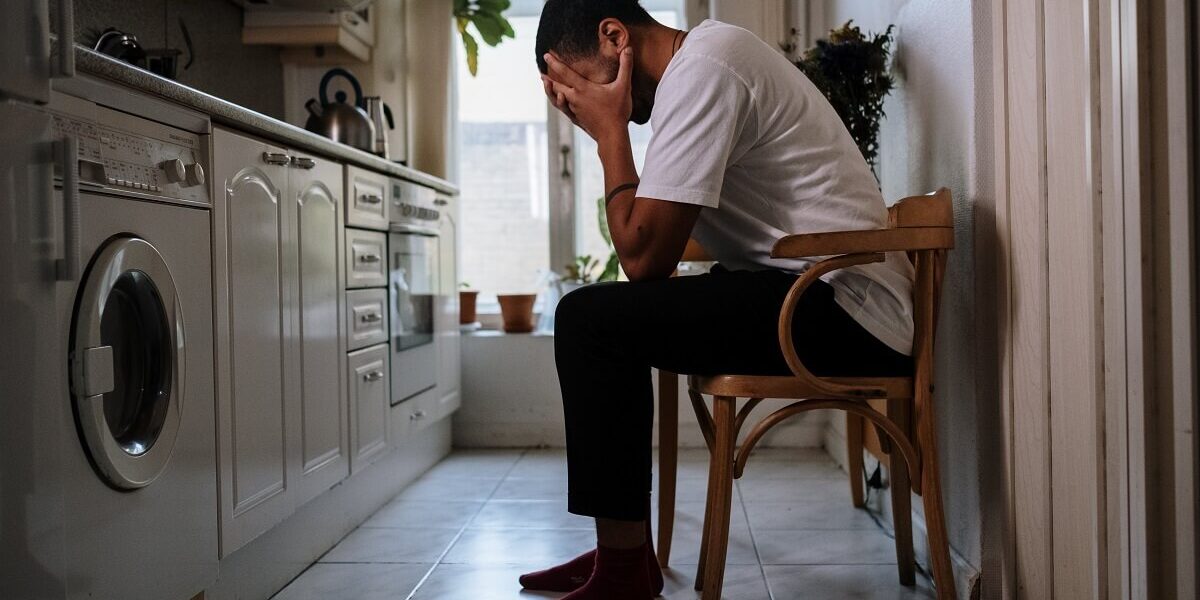 man with hands on face tired