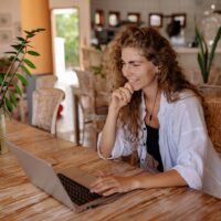 smiling woman in home on virtual call