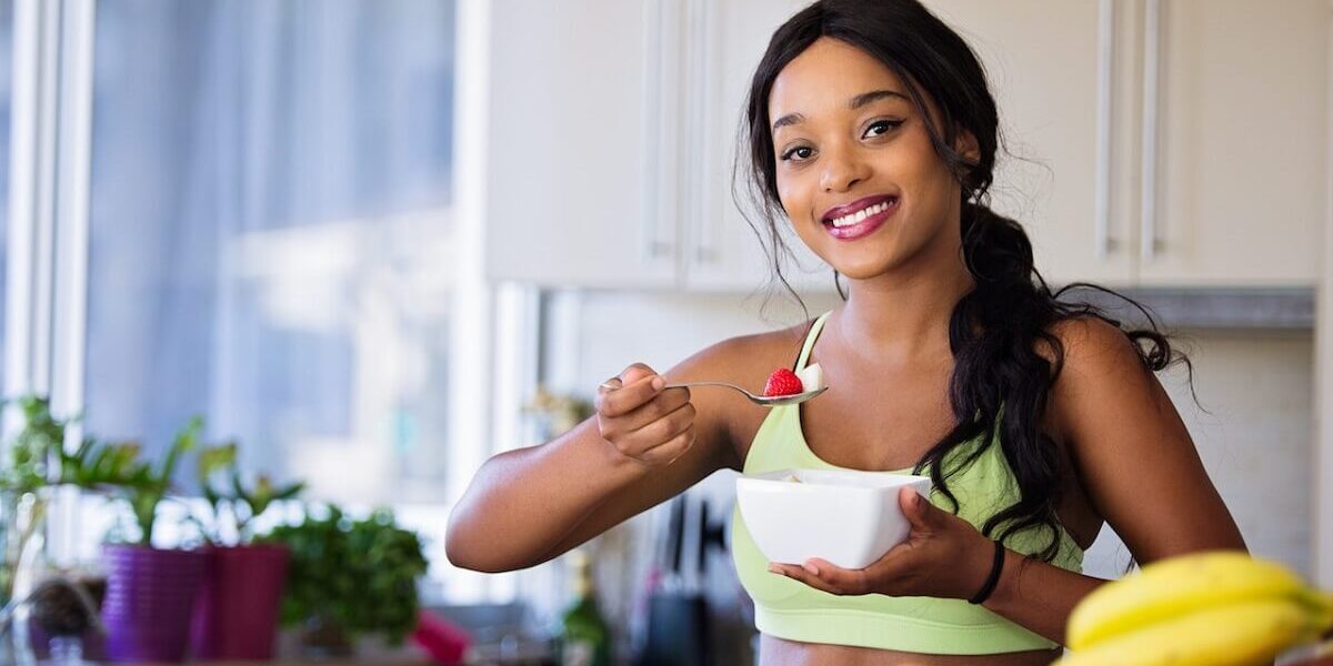 smiling woman eating healthy food